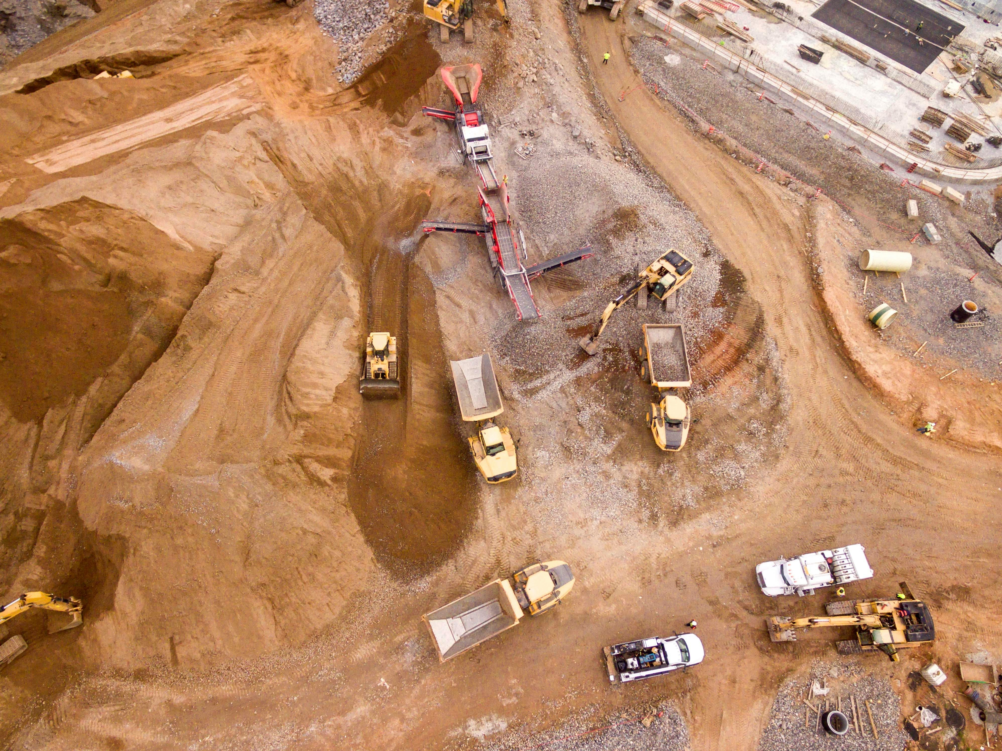 Aerial view of a construction site with various pieces of construction equipment.