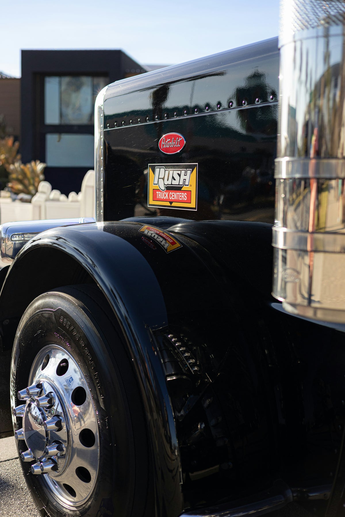 Close-up of a truck's front grille and tire.